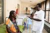 Nurse Hayat attends to woman at a clinic in Juba